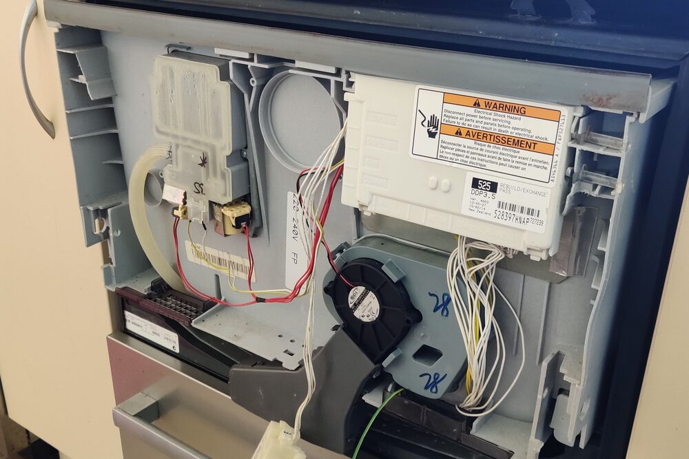 Dishwasher control board and wiring exposed for repair